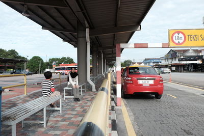 Cars on road in city against sky