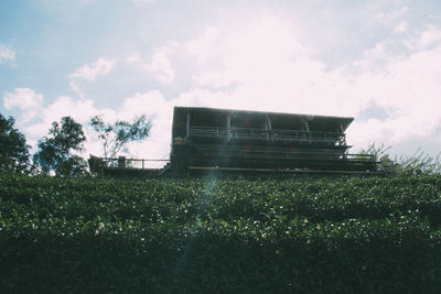 Built structure on field against sky