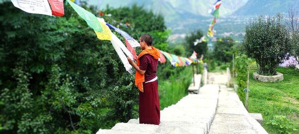 Side view of woman holding umbrella