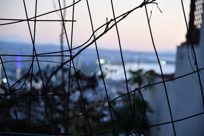 Close-up of chainlink fence against sky