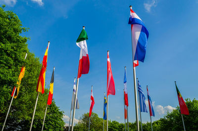 Low angle view of flags against sky