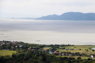 High angle view of sea and mountains against sky