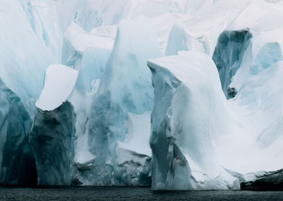 Scenic view of glaciers by sea