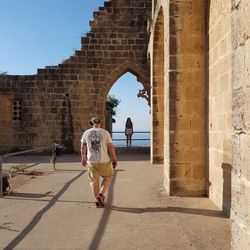 People walking in front of historical building