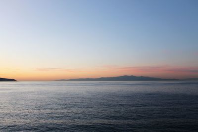 Scenic view of sea against clear sky during sunset