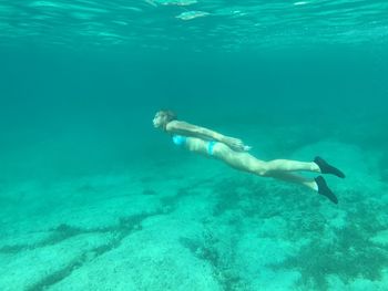 Side view full length of woman snorkeling in sea