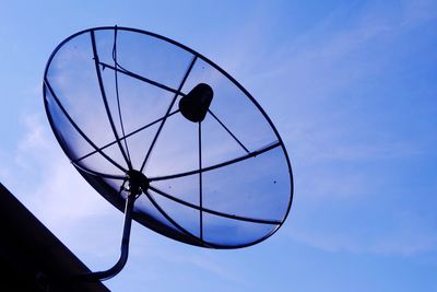 Low angle view of camera against blue sky