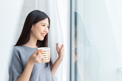 Young woman drinking coffee cup