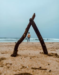 Boy on beach against sky