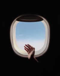 Woman looking through airplane window