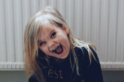 Portrait of cheerful girl at home