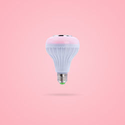 Close-up of light bulb against pink background