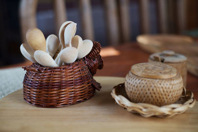 Close-up of wooden spoons in basket on table