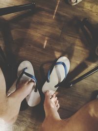 Low section of woman wearing shoes