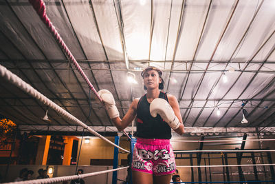 Full length of woman standing against wall