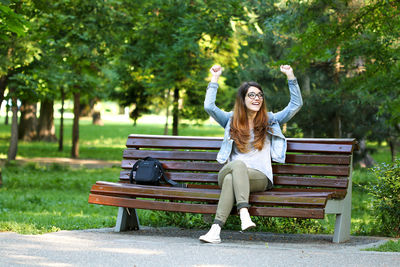 Portrait of young woman sitting in park