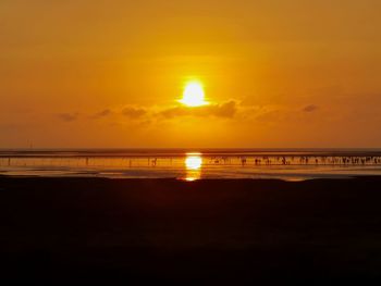 Scenic view of sea against orange sky