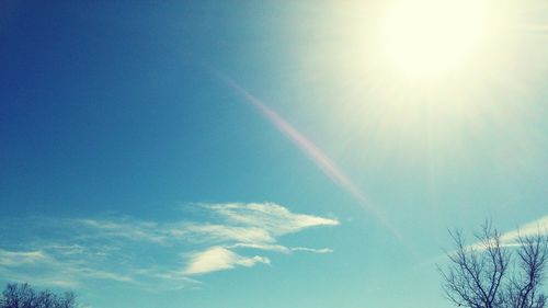 Low angle view of vapor trail in blue sky