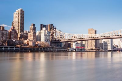 Bridge over river with city in background