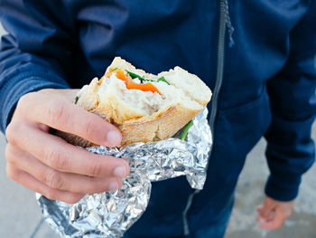 Close-up of man holding sandwich