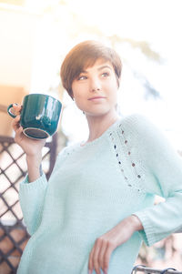 Portrait of teenage boy drinking coffee