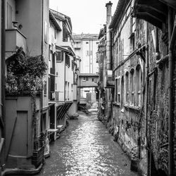 Narrow street amidst buildings in city