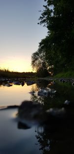 Scenic view of lake against sky at sunset
