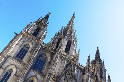 Low angle view of traditional building against clear blue sky