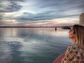 Portrait of woman looking at sea against sky