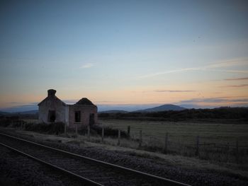 View of railroad track against cloudy sky