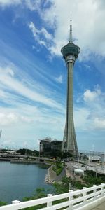 Tower bridge over river against sky in city