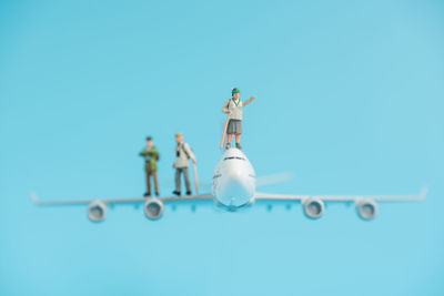 Toy airplane and figurines on blue backgrounds