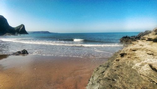 Scenic view of sea against clear blue sky