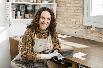 Female artist preparing a plate for an art print.