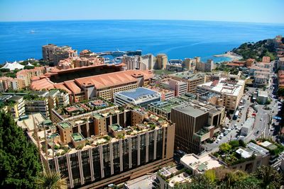 High angle view of buildings by sea against sky