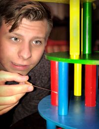 Man playing with multi colored decoration at home