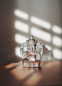 Close-up of figurine on table at home