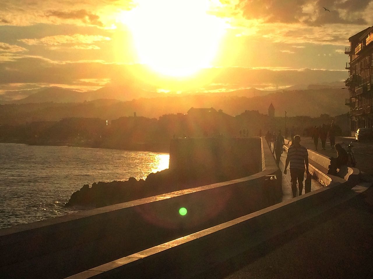 sunset, sun, sky, water, silhouette, sunlight, sunbeam, leisure activity, lifestyles, lens flare, sea, men, cloud - sky, scenics, person, nature, river, reflection, orange color