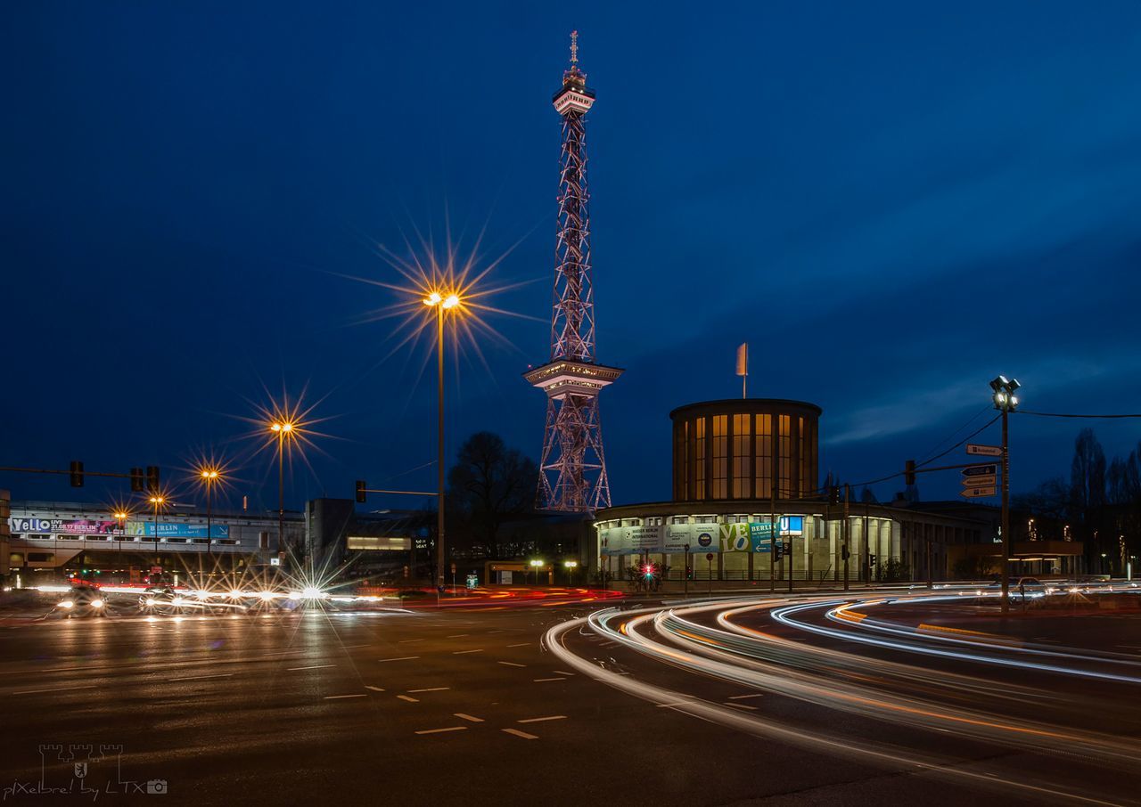 illuminated, night, light trail, architecture, built structure, transportation, long exposure, speed, street light, city, building exterior, outdoors, sky, travel destinations, motion, road, no people, high street