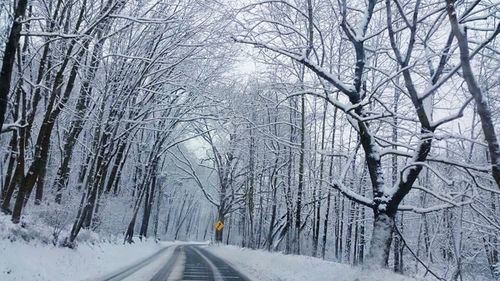 Road passing through snow covered landscape