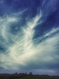 Scenic view of landscape against cloudy sky