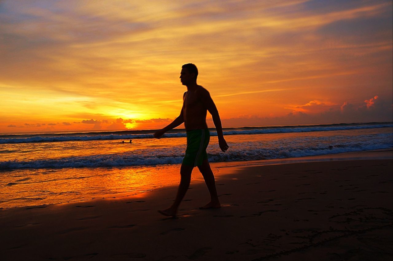 sunset, sea, beach, horizon over water, shore, sky, water, orange color, silhouette, full length, scenics, beauty in nature, sand, tranquil scene, tranquility, leisure activity, lifestyles, idyllic