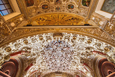 Directly below shot of ornate ceiling in temple