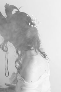 Close-up of woman against white background