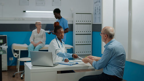 Doctor talking to patient at hospital