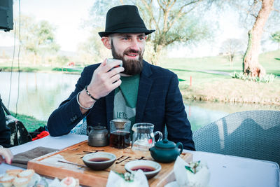 Portrait of young man sitting at table