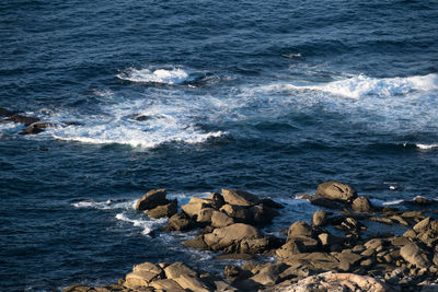 Superior view of sea waves hitting rocks on the coast