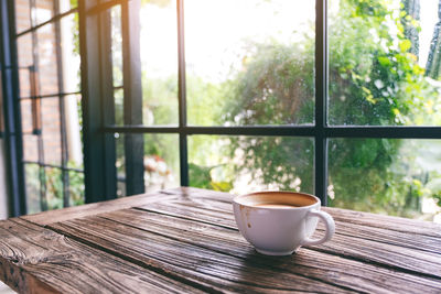 Close-up of coffee on table against window