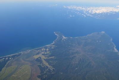 Aerial view of sea and mountain against sky