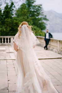 Rear view of woman with white umbrella